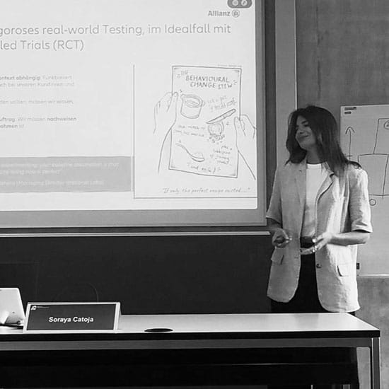 Woman presenting a business news slide at a conference